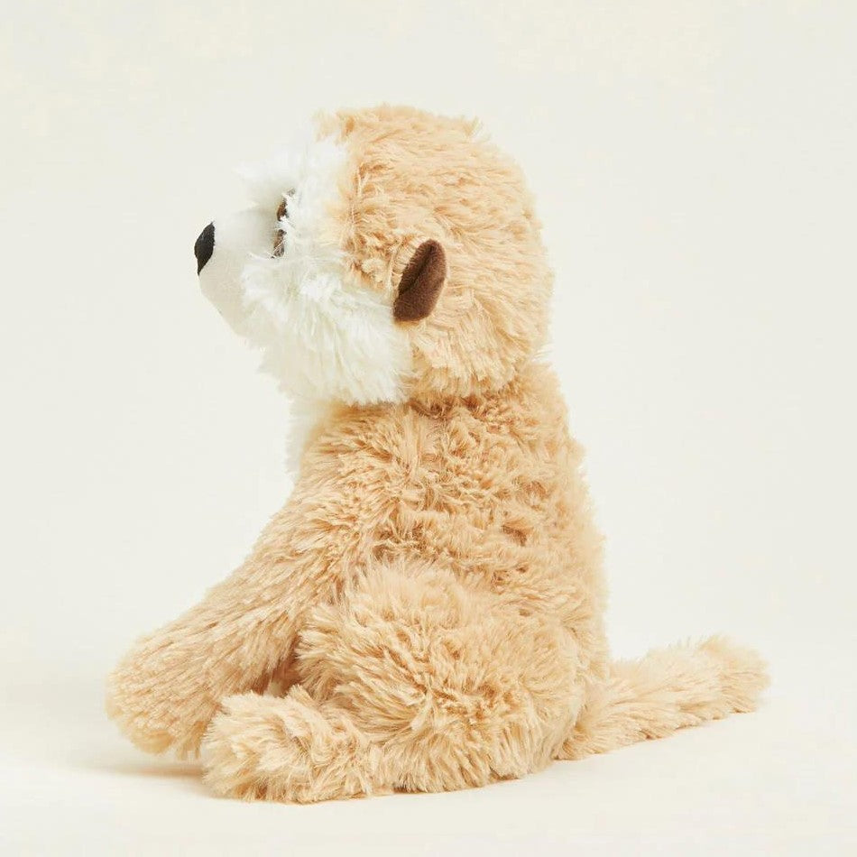 Fluffy stuffed animal sitting, side profile view.
