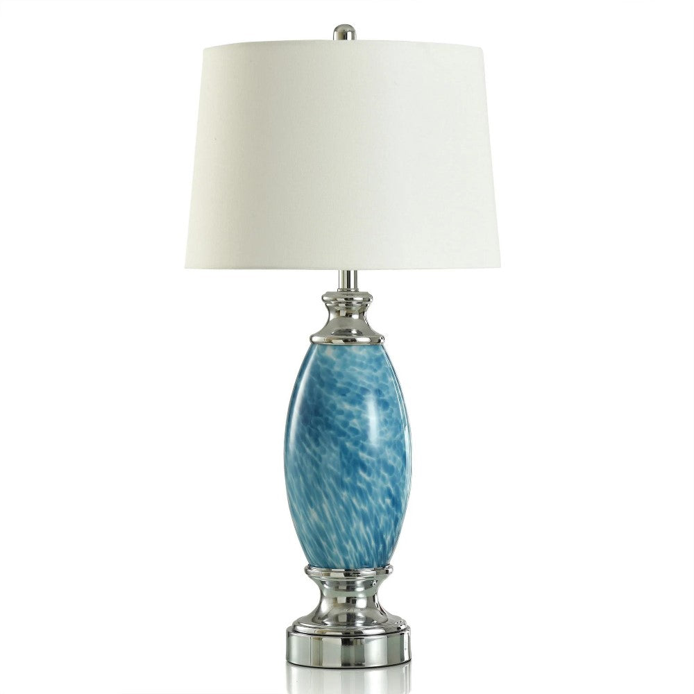 Elegant lamp with blue ceramic base and white shade.