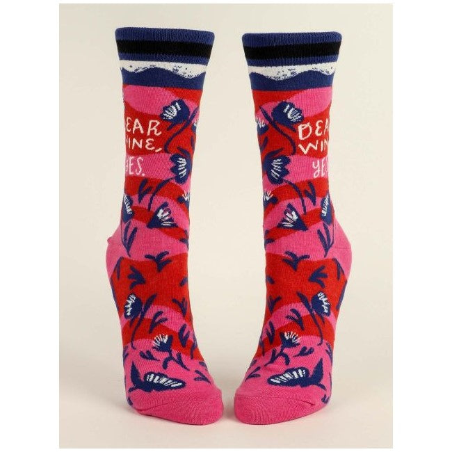 Pink socks with floral patterns and "Dear Wine, Yes" text.