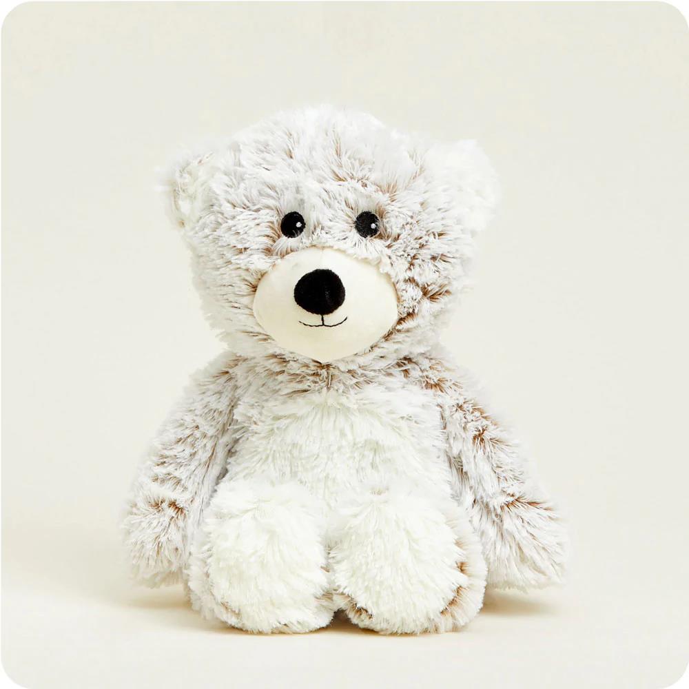 Fluffy teddy bear with a cute face sitting upright.