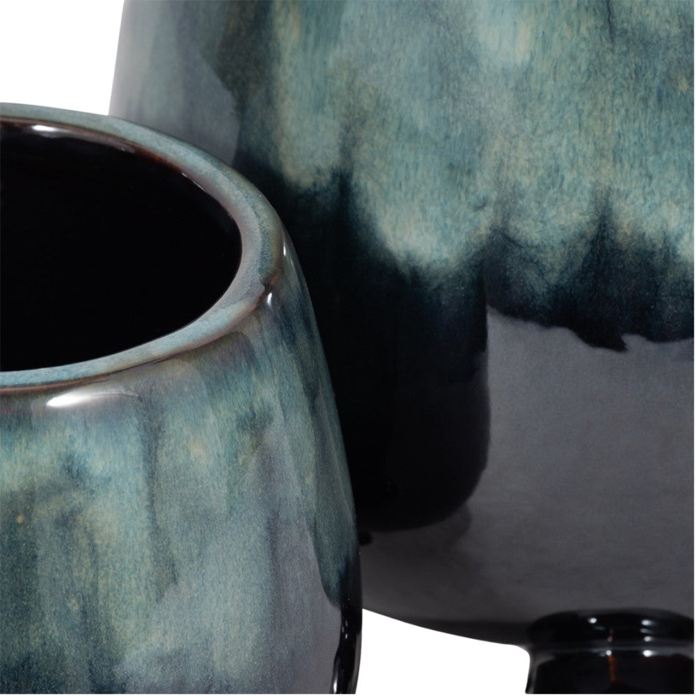 Blue-green ceramic vases with a glossy finish.