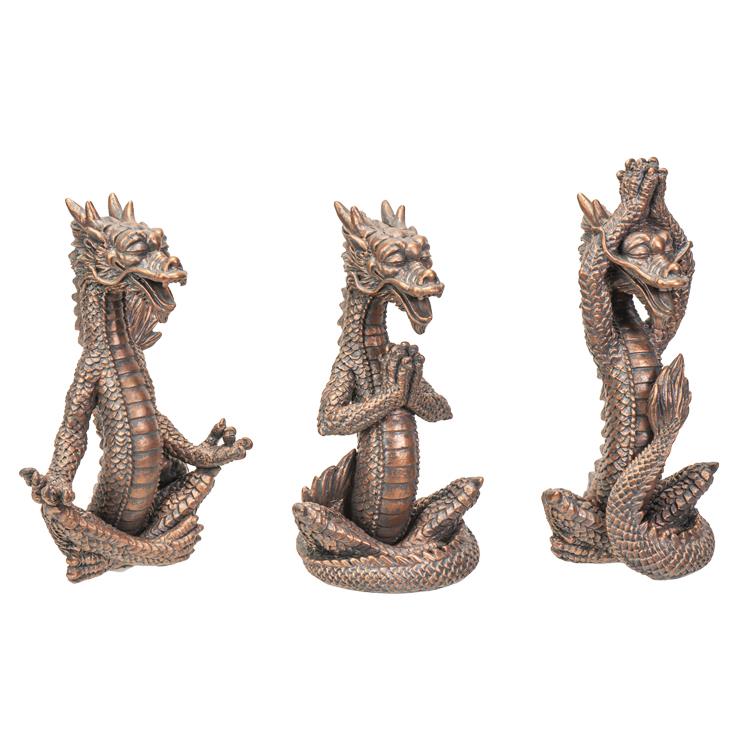 Three dragon sculptures in meditative poses.