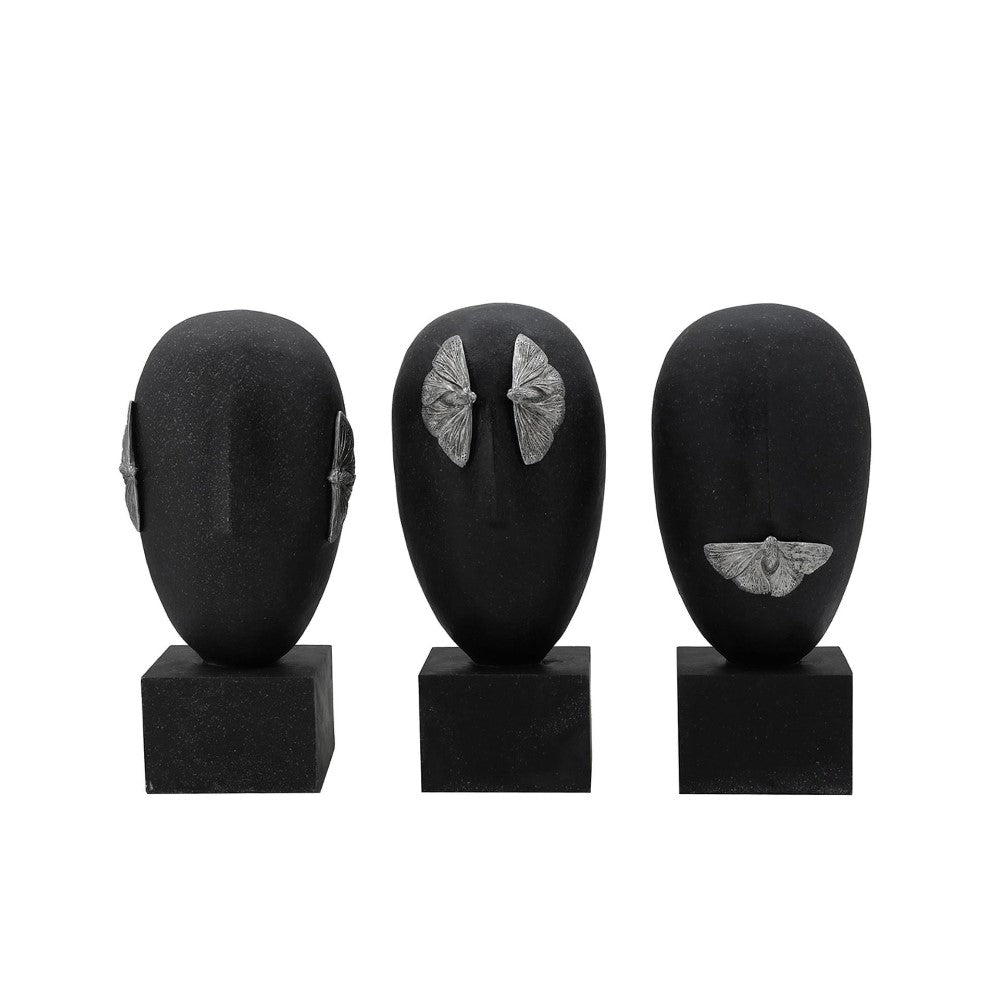 Three black mannequin heads with silver moth details.