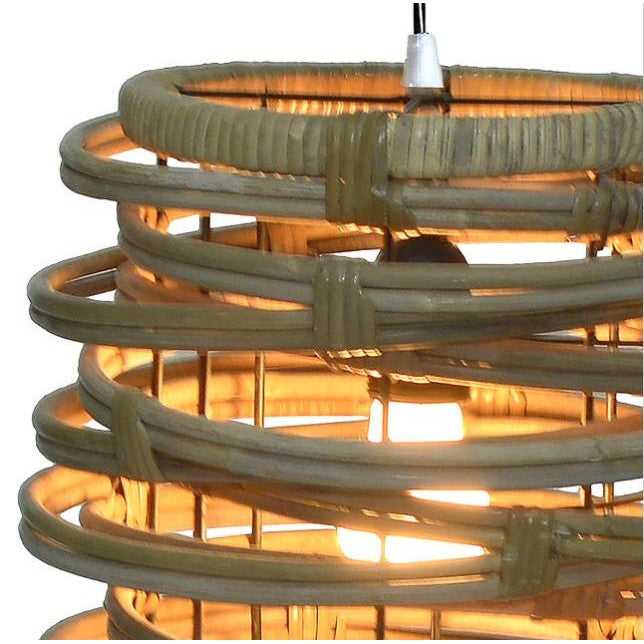 Woven rattan lampshade with a warm glowing light bulb inside.