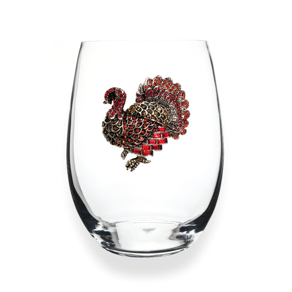 A glass with a jeweled turkey design on it.