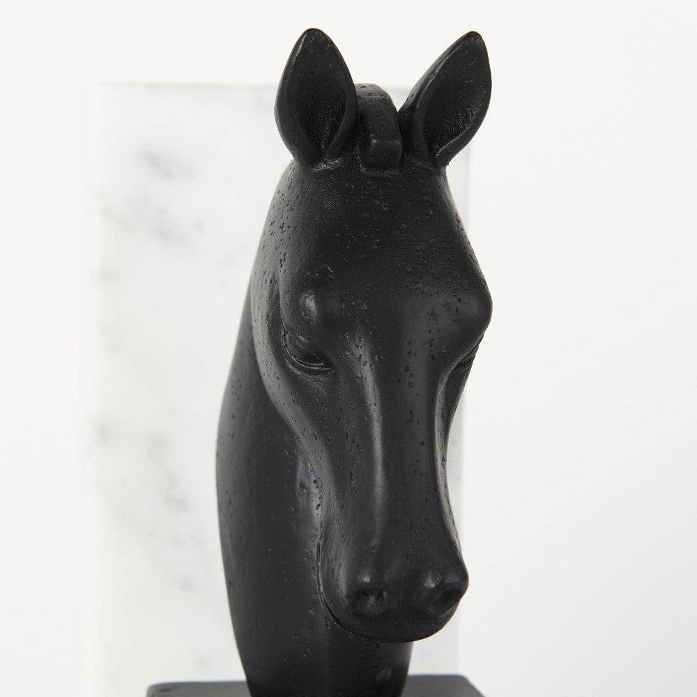 Black horse head sculpture against a white background.