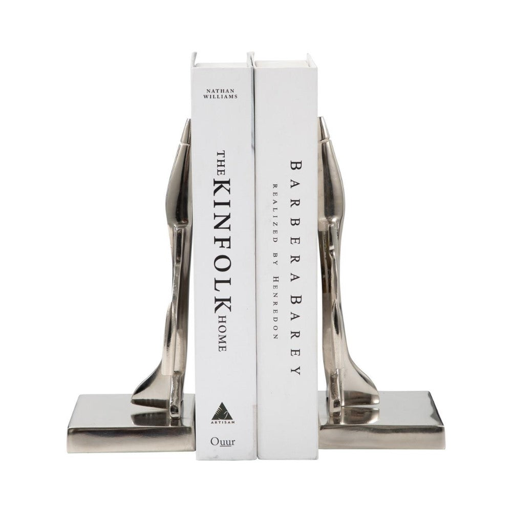 Two books with silver shoe-shaped bookends.