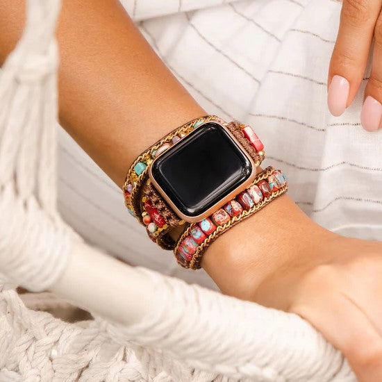 Smartwatch with a colorful, beaded strap on a wrist.