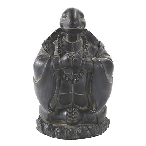 A carved turtle figurine with a robe and beaded necklace.