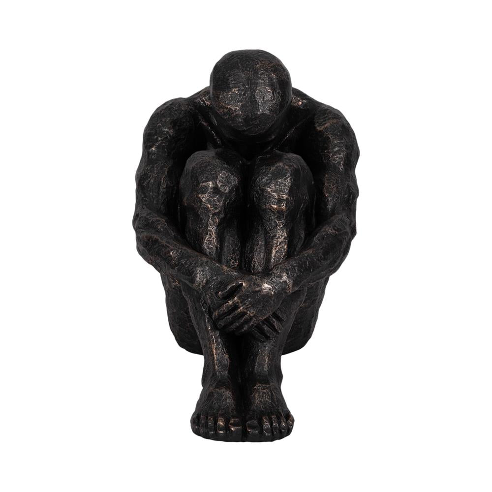 Bronze figure seated with knees up, arms crossed.