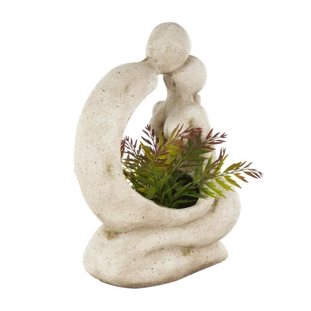 Abstract stone sculpture planter with green foliage.