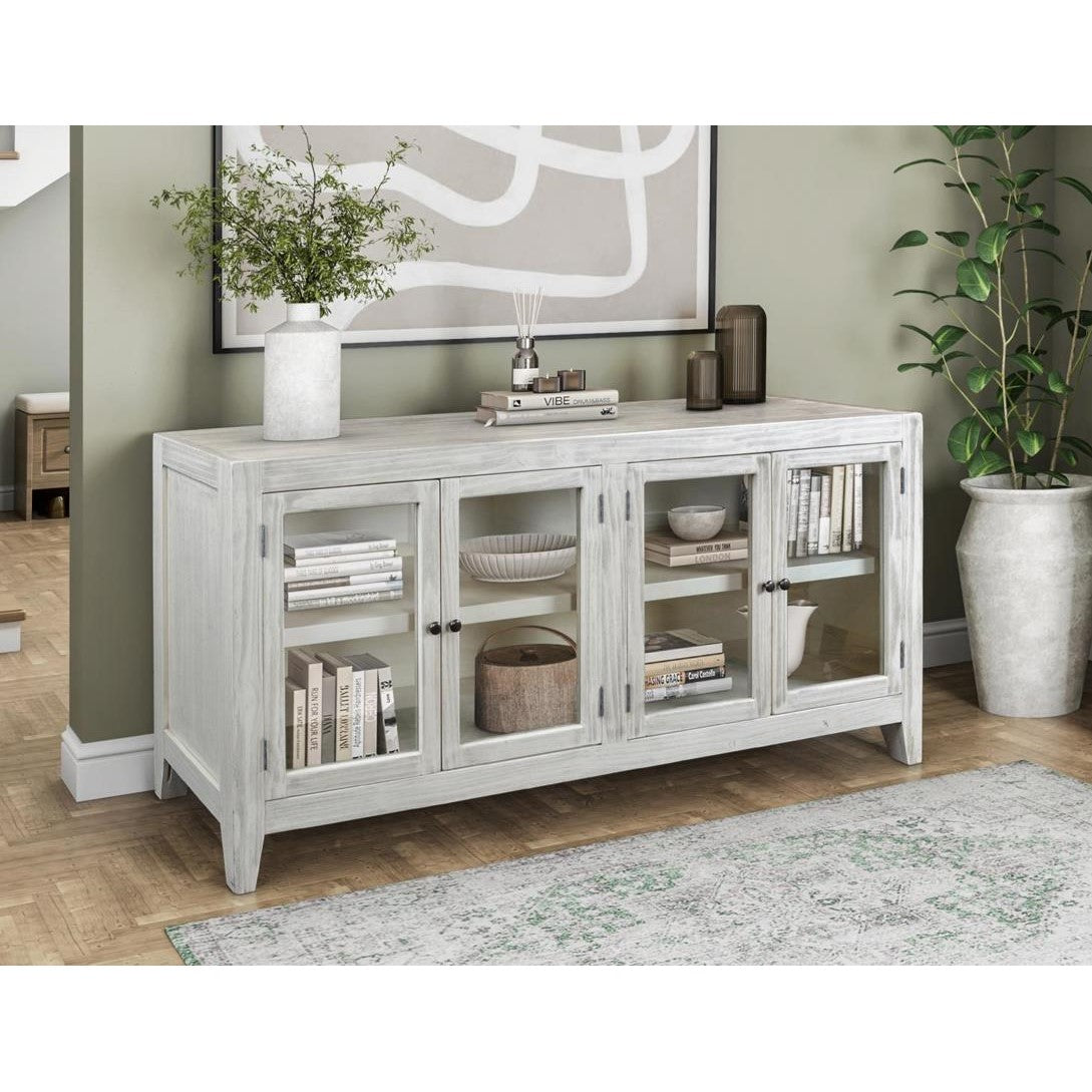 White cabinet with decor, plants, and abstract art in a cozy room.