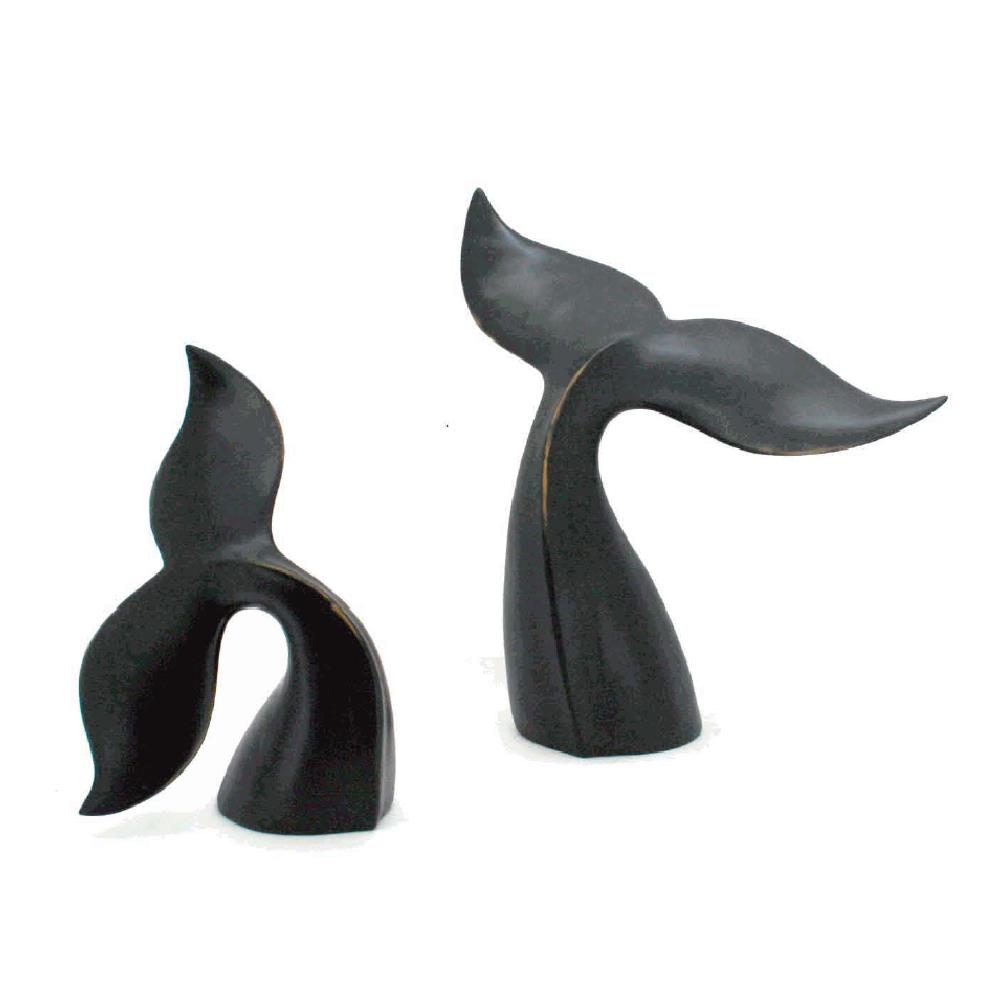 Two abstract black whale tail sculptures on a white background.