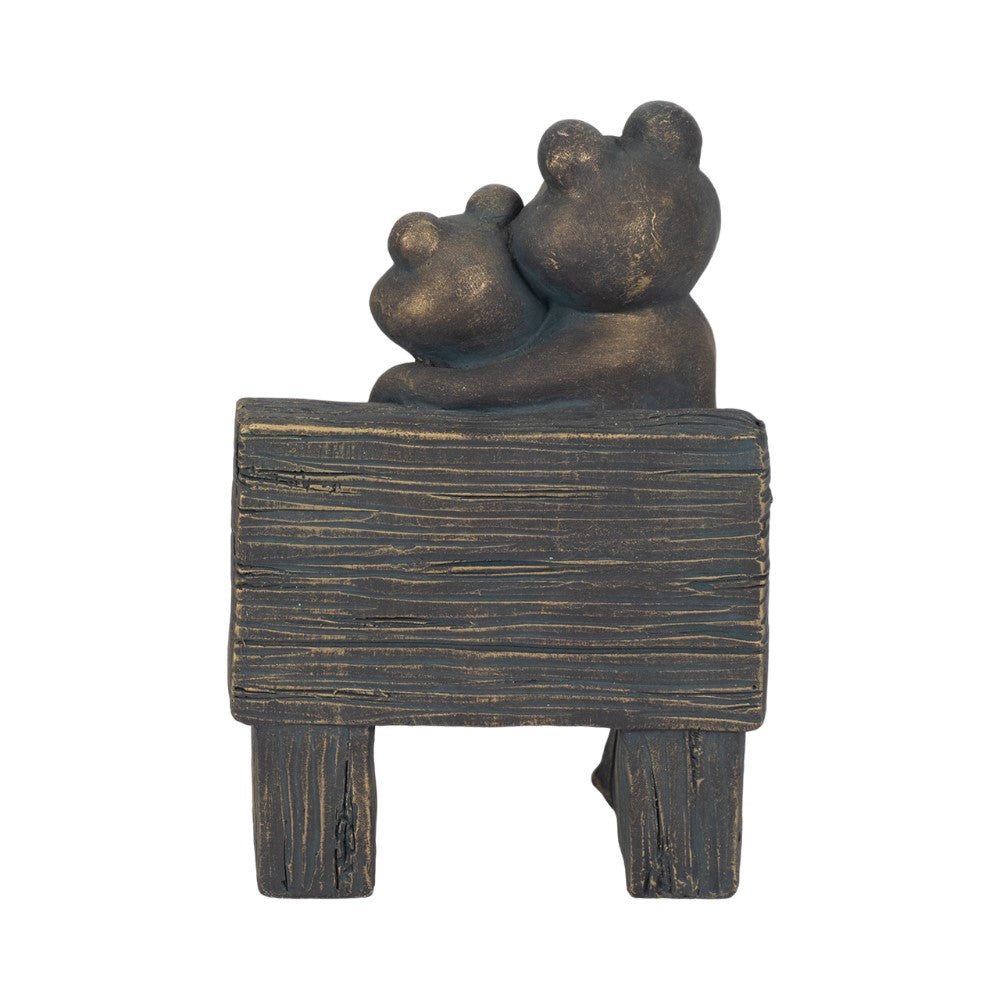 Two bear-like figures sitting together on a wooden bench sculpture.