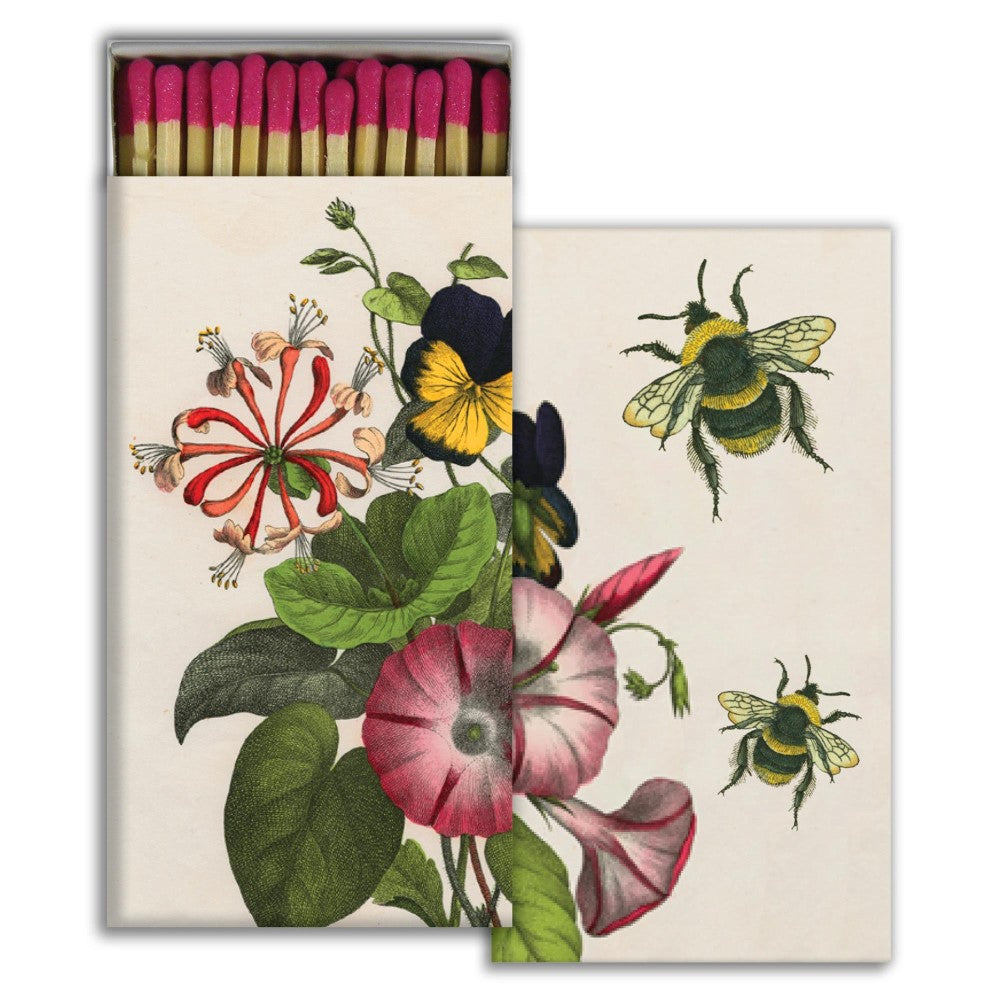Box of matches with illustrated flowers and bees.