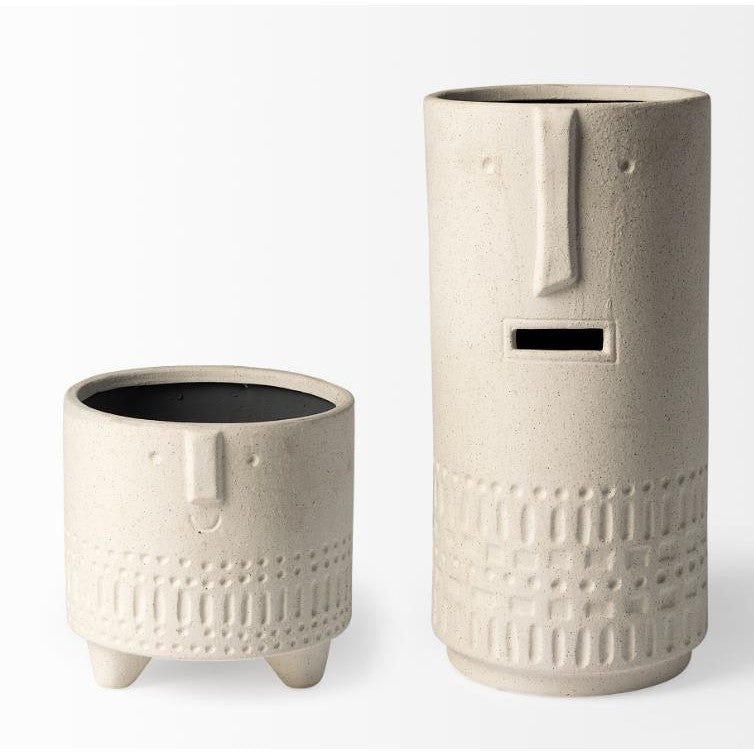 Two textured, face-shaped ceramic planters in beige.