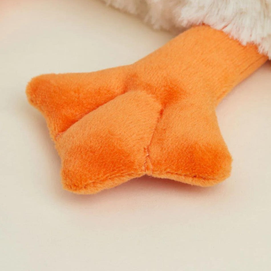 Plush orange duck foot on a light background.