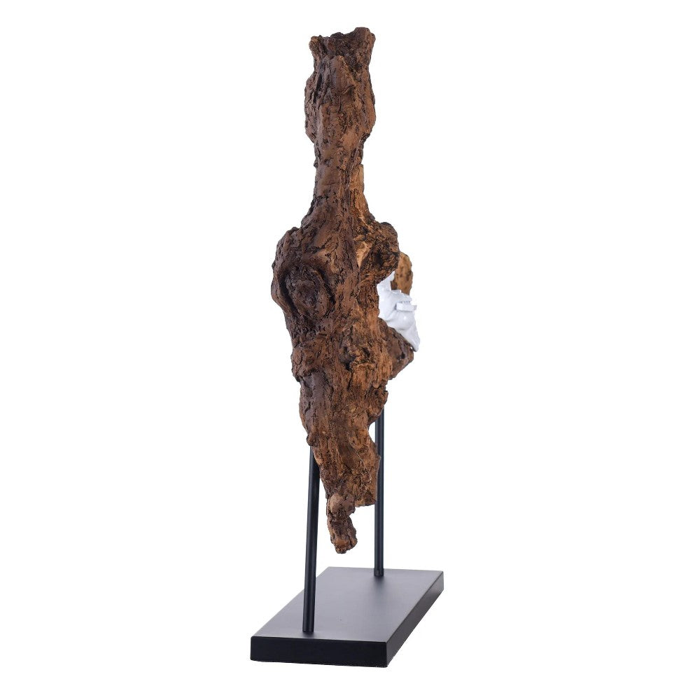 Abstract sculpture of textured wood on a stand.