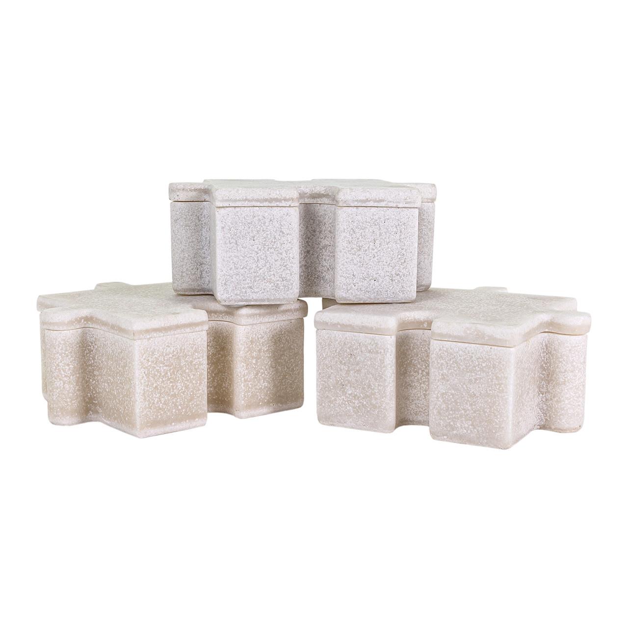 Stacked, textured star-shaped stone blocks in neutral tones.