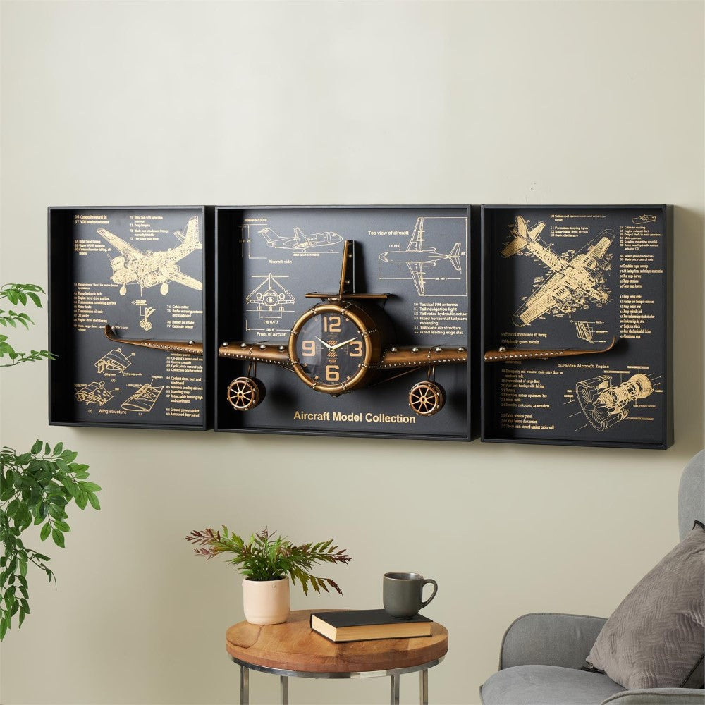 Wall clock with airplane design and blueprints, beside a cozy chair and table setup.