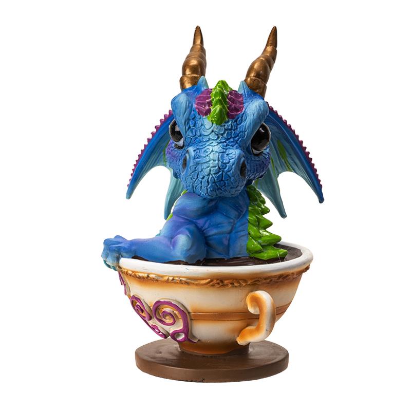 Blue dragon in a teacup with golden horns and colorful accents.