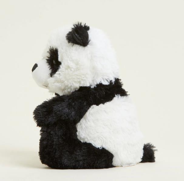 Fluffy toy panda sitting sideways on a plain background.