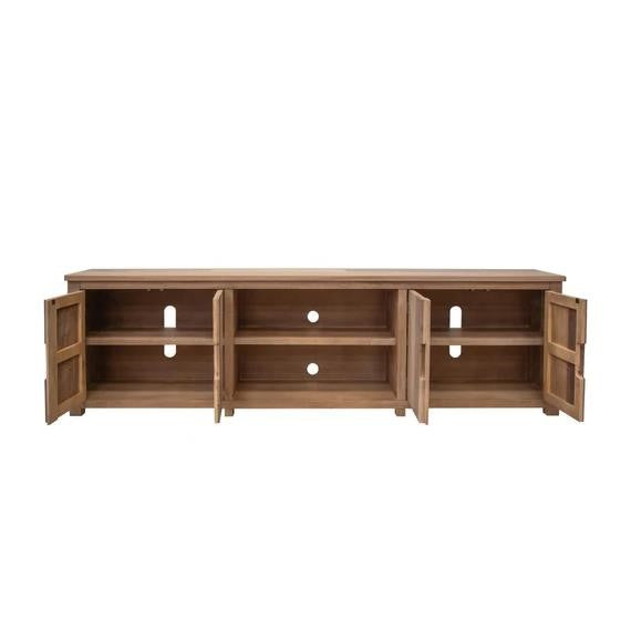 Wooden sideboard with decor: lamp, bowl, and vase on top, greenery on the shelf.
