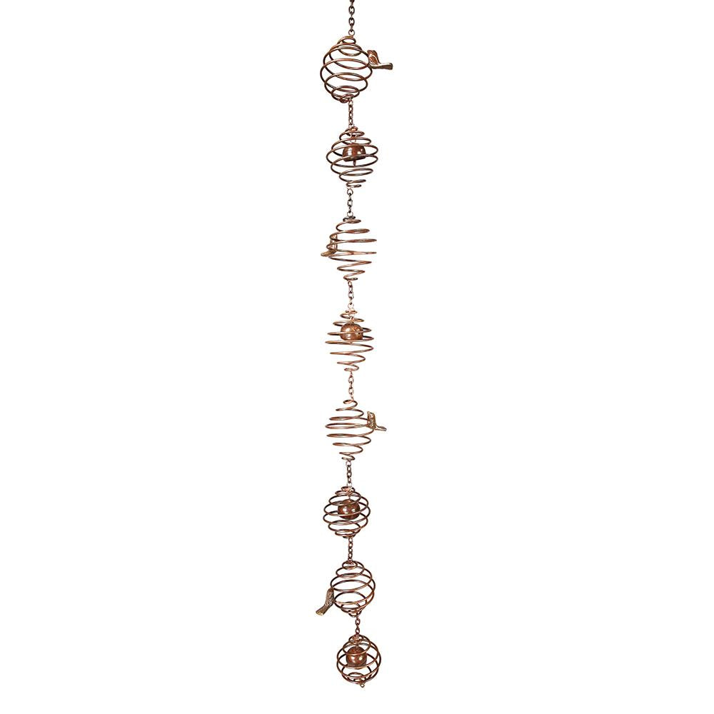 Bronze-colored spiral wind chime with bird accents hanging vertically.