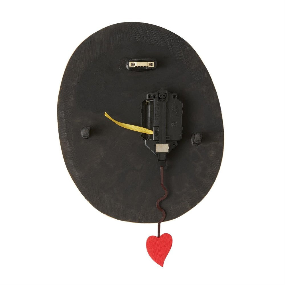 Back of an oval object with a red heart and mechanical parts attached.