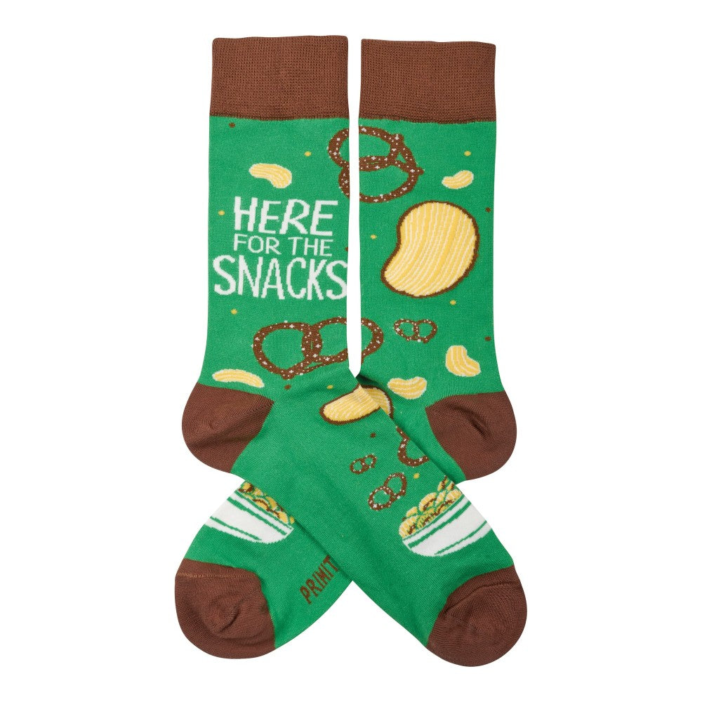 Green socks with snack designs and "HERE FOR THE SNACKS" text.