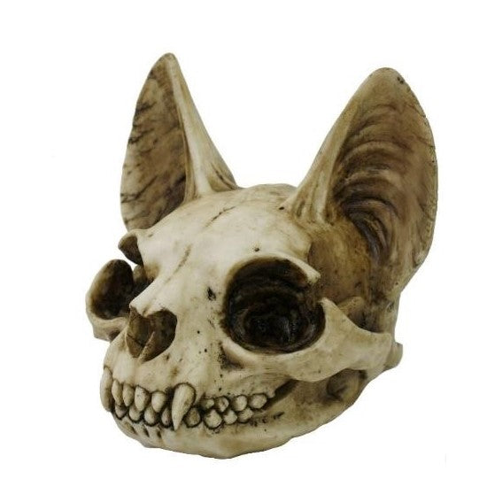 Bat-like skull sculpture with large ears and sharp teeth.