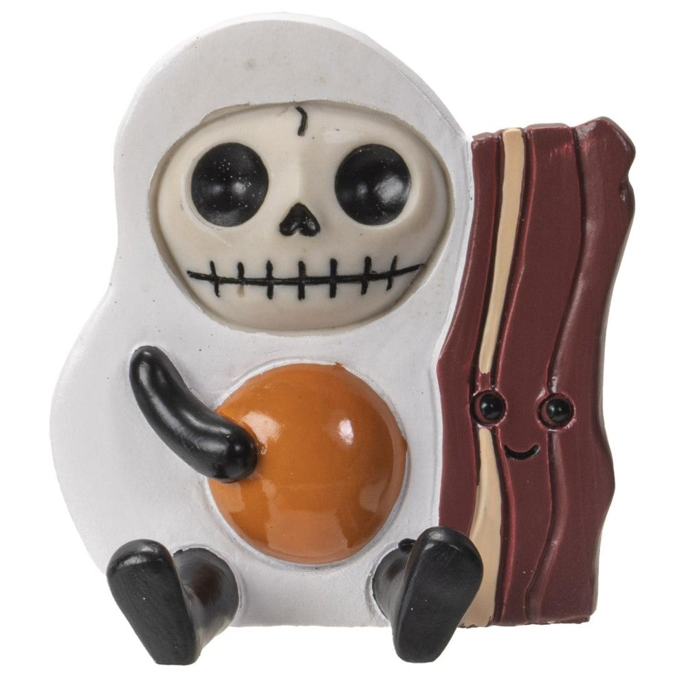 Egg and bacon figurine with a skull face and playful expression.
