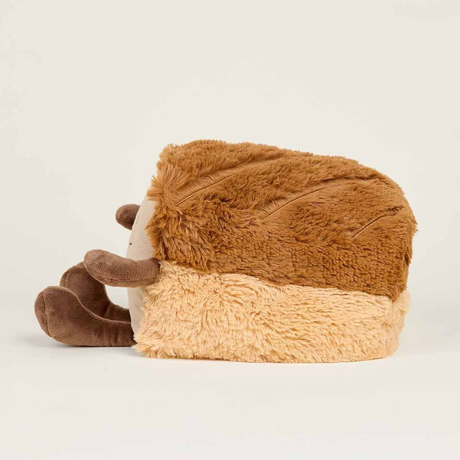 Plush woolly mammoth toy lying on its side.