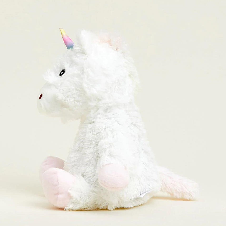 Fluffy unicorn plush with a rainbow horn, sitting sideways.