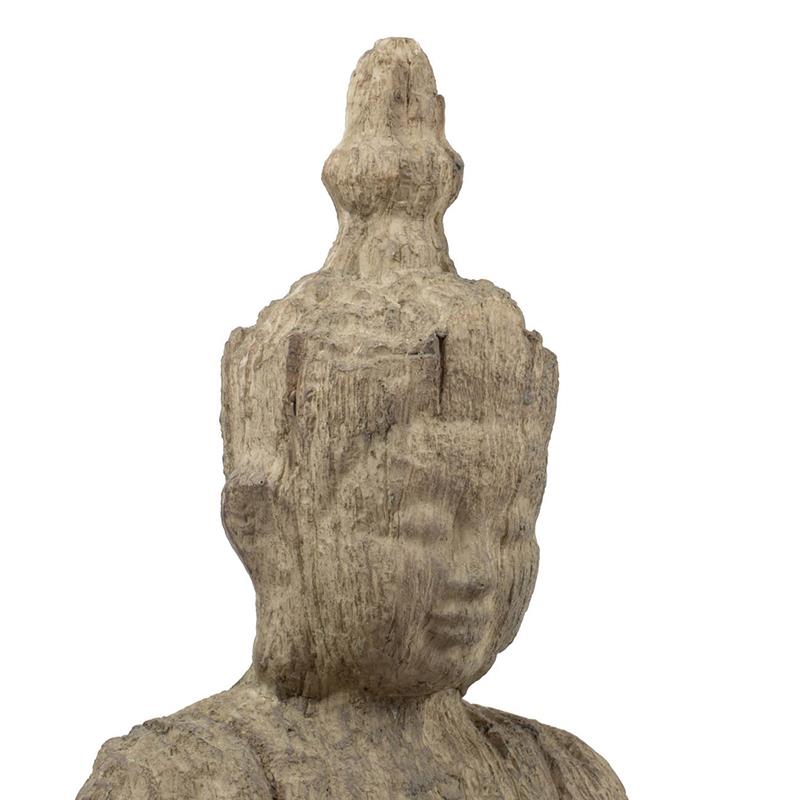 Stone-textured statue of a serene figure with ornate headpiece.