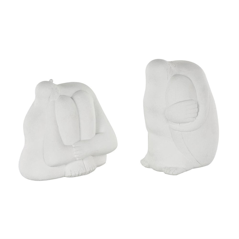 Two abstract white statues with rounded forms.