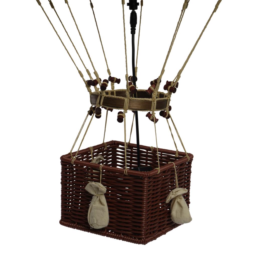 Wicker hot air balloon basket with hanging ropes and sandbags.