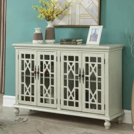 White cabinet with glass doors, books, and decor against a teal wall.