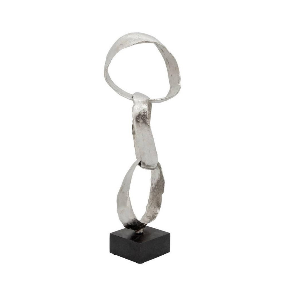 Abstract silver sculpture with three linked loops, on a black square base.