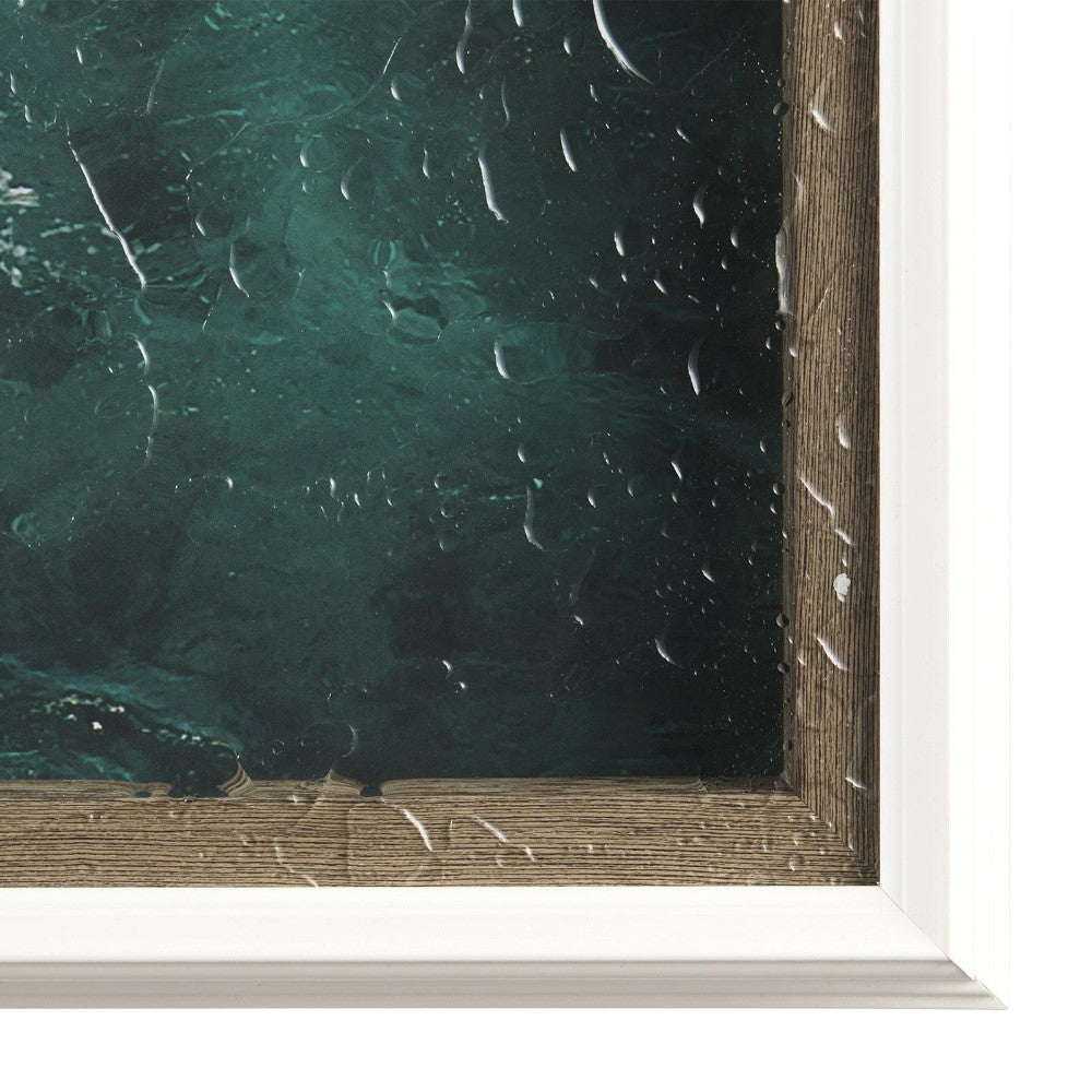 Framed artwork with raindrops on glass cover.