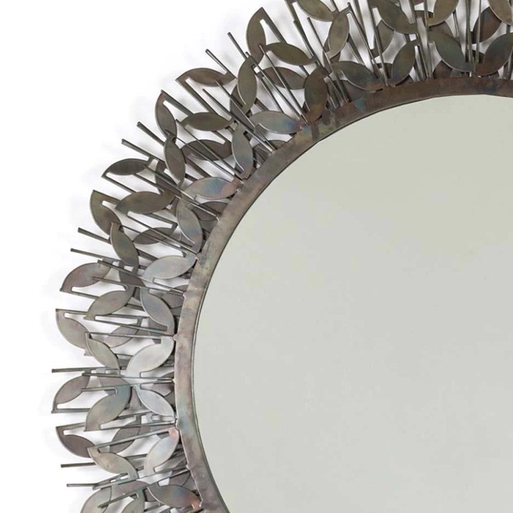 Round mirror with decorative metal leaf border.