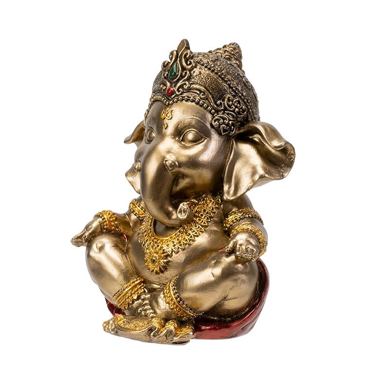 Golden Ganesha statue adorned with intricate jewelry.
