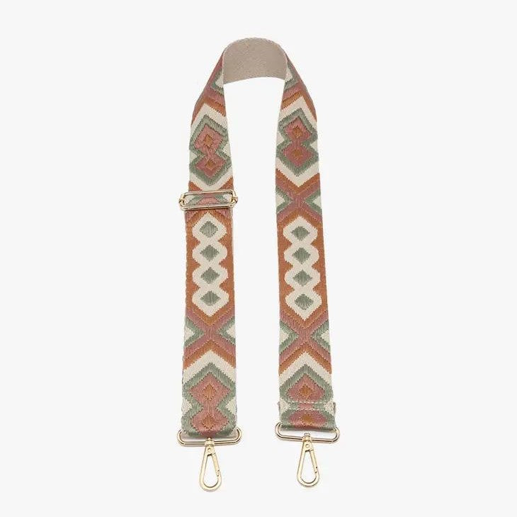Geometric patterned bag strap with gold clasps.
