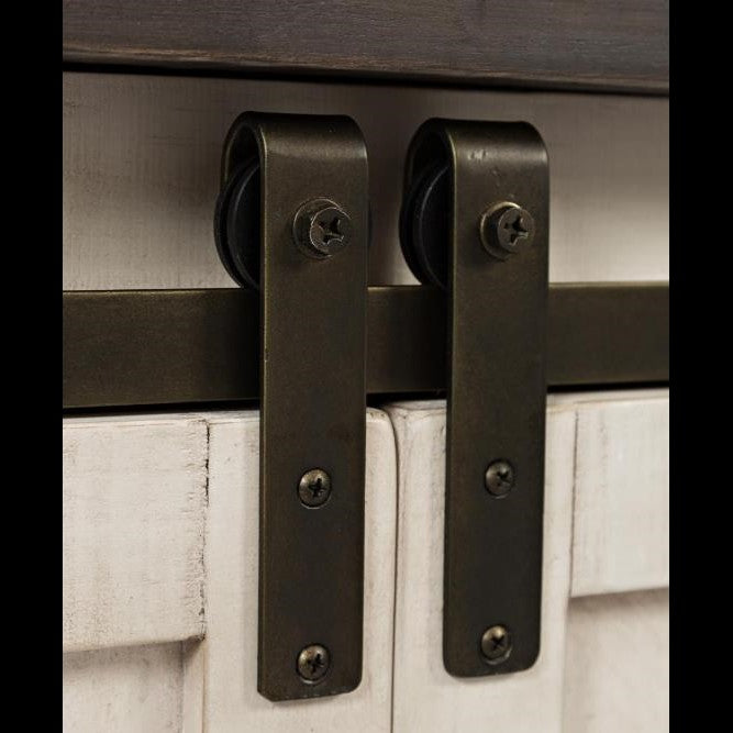 Metal sliding door hardware on a rustic, light wooden door.