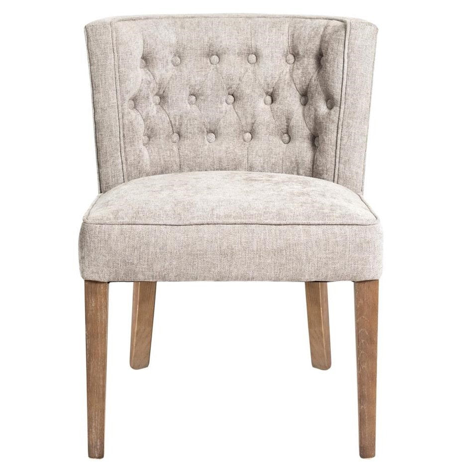 Beige upholstered chair with tufted back and wooden legs.