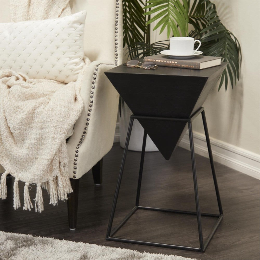 Cozy chair, geometric side table, book, cup, greenery.