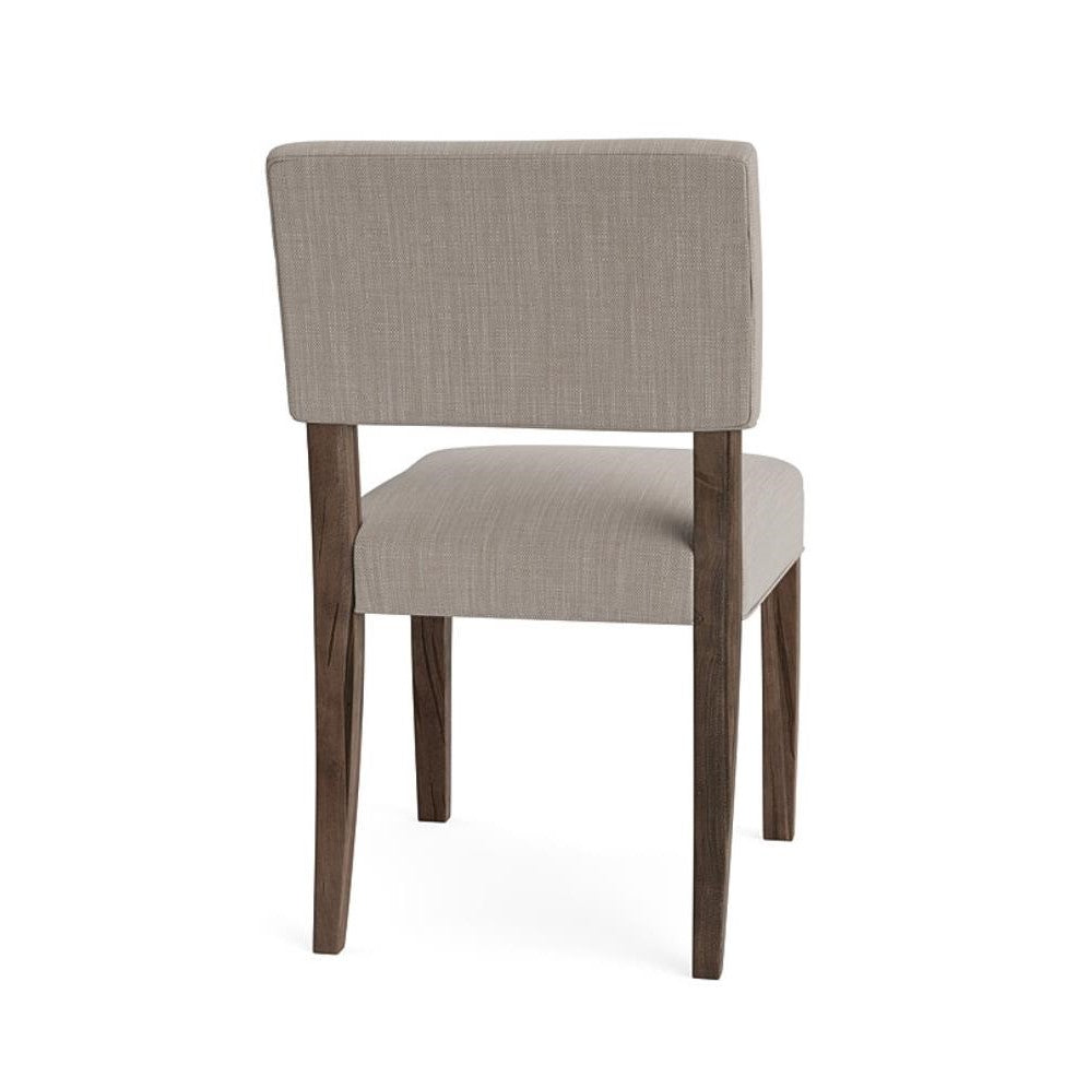 Gray upholstered chair with wooden legs, viewed from the back.