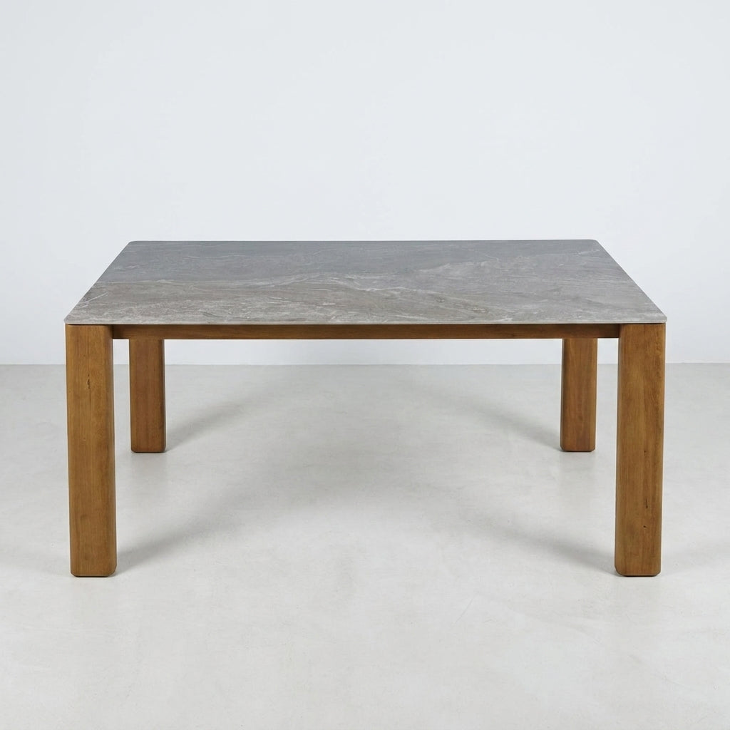 Square table with wooden legs and a gray stone top.