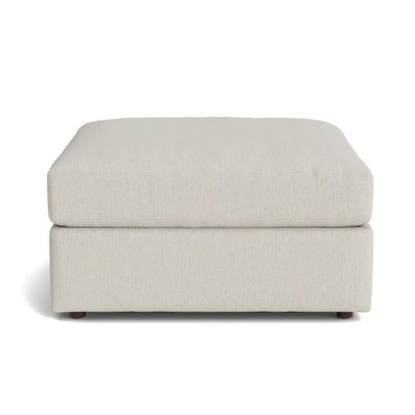 Cream-colored ottoman with a cushioned top and small feet.