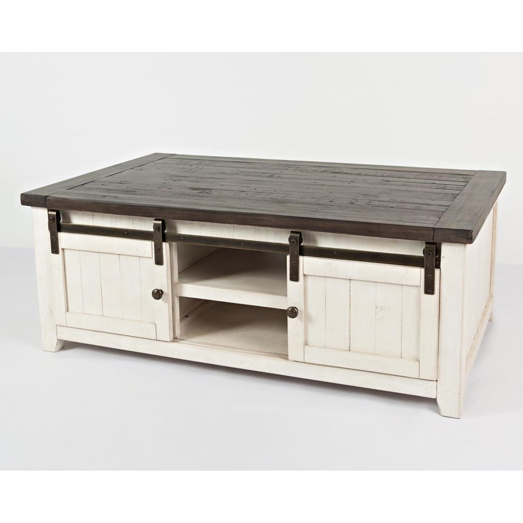 Rustic white coffee table with dark wooden top and sliding barn doors.